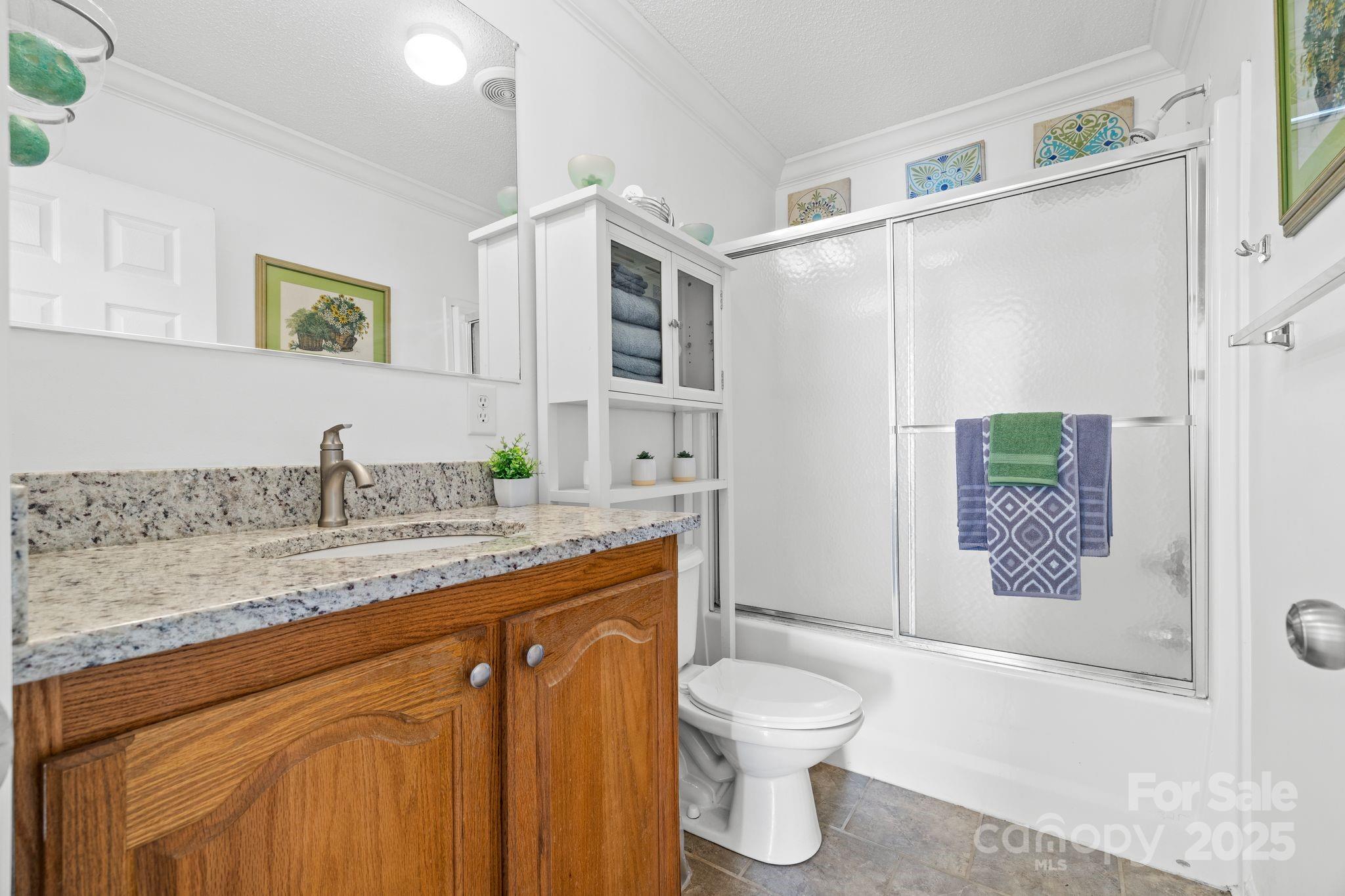118 Grain Drive Stony Point, NC 28678 - Photo 15 of 31 a bathroom with a granite countertop sink toilet and shower
