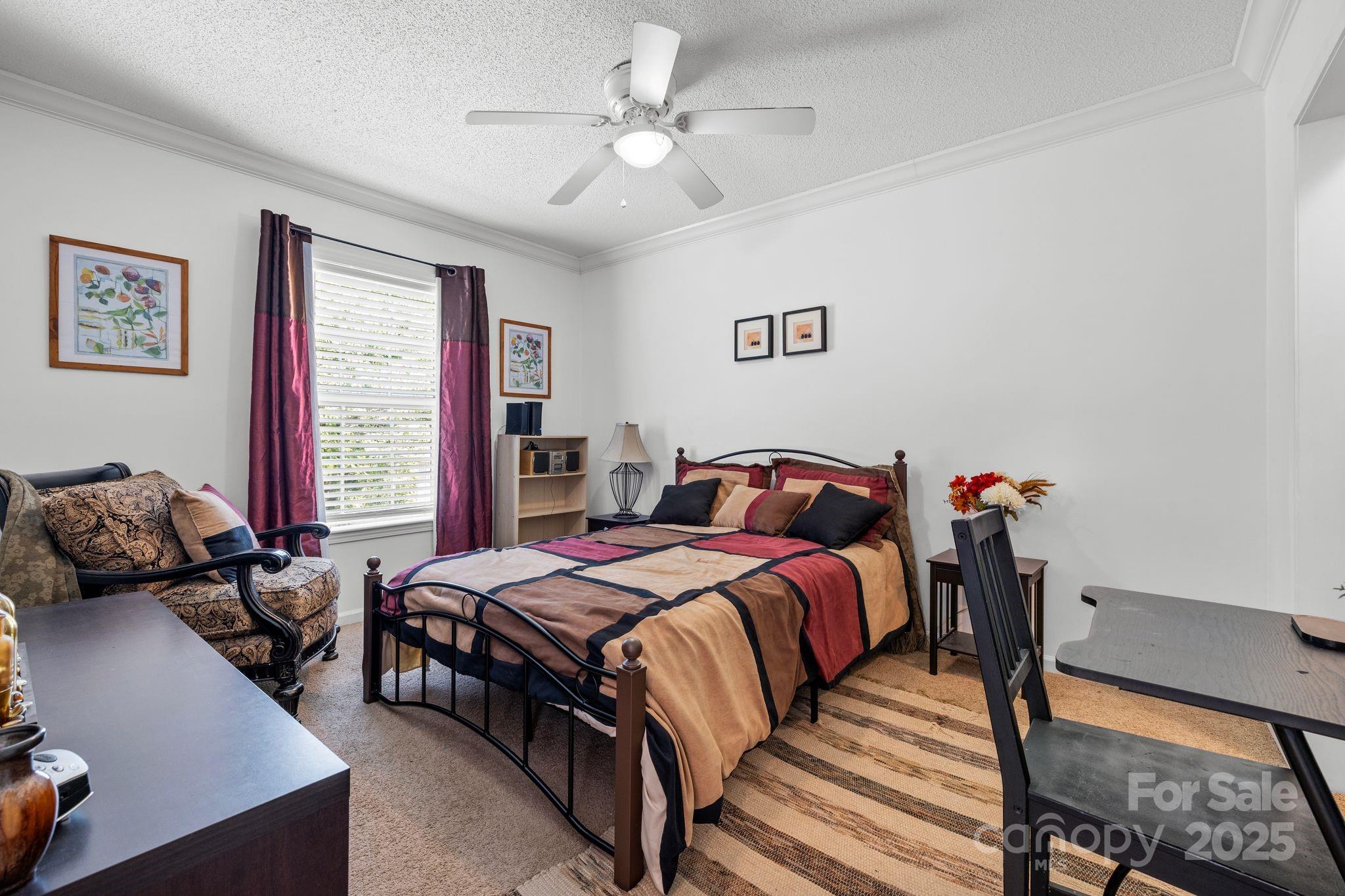 118 Grain Drive Stony Point, NC 28678 - Photo 16 of 31 a bedroom with bed a couch and a window