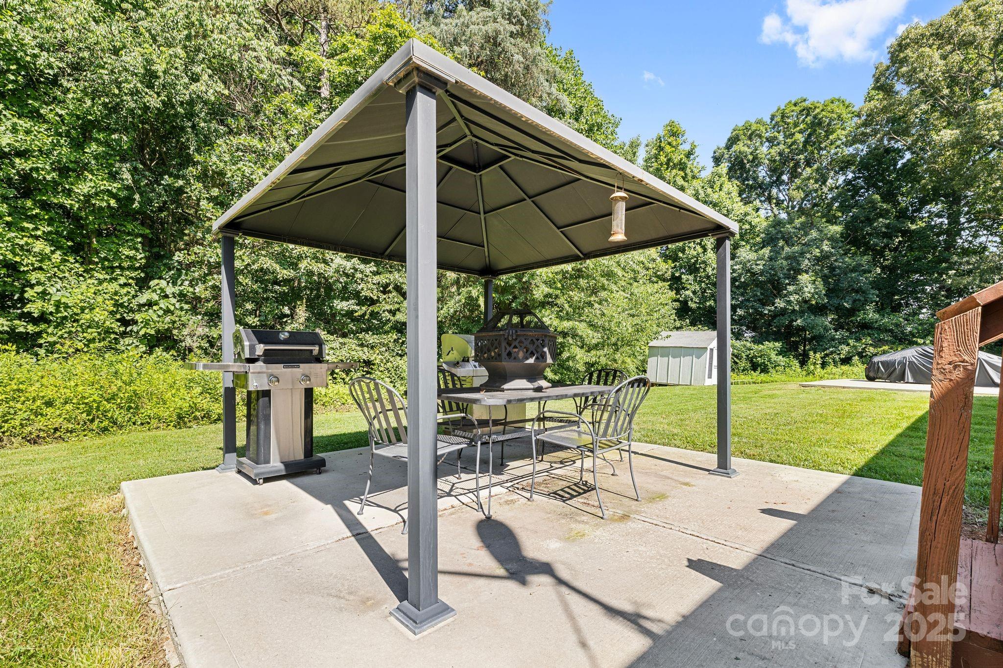 118 Grain Drive Stony Point, NC 28678 - Photo 23 of 31 a view of backyard with table and chairs under an umbrella
