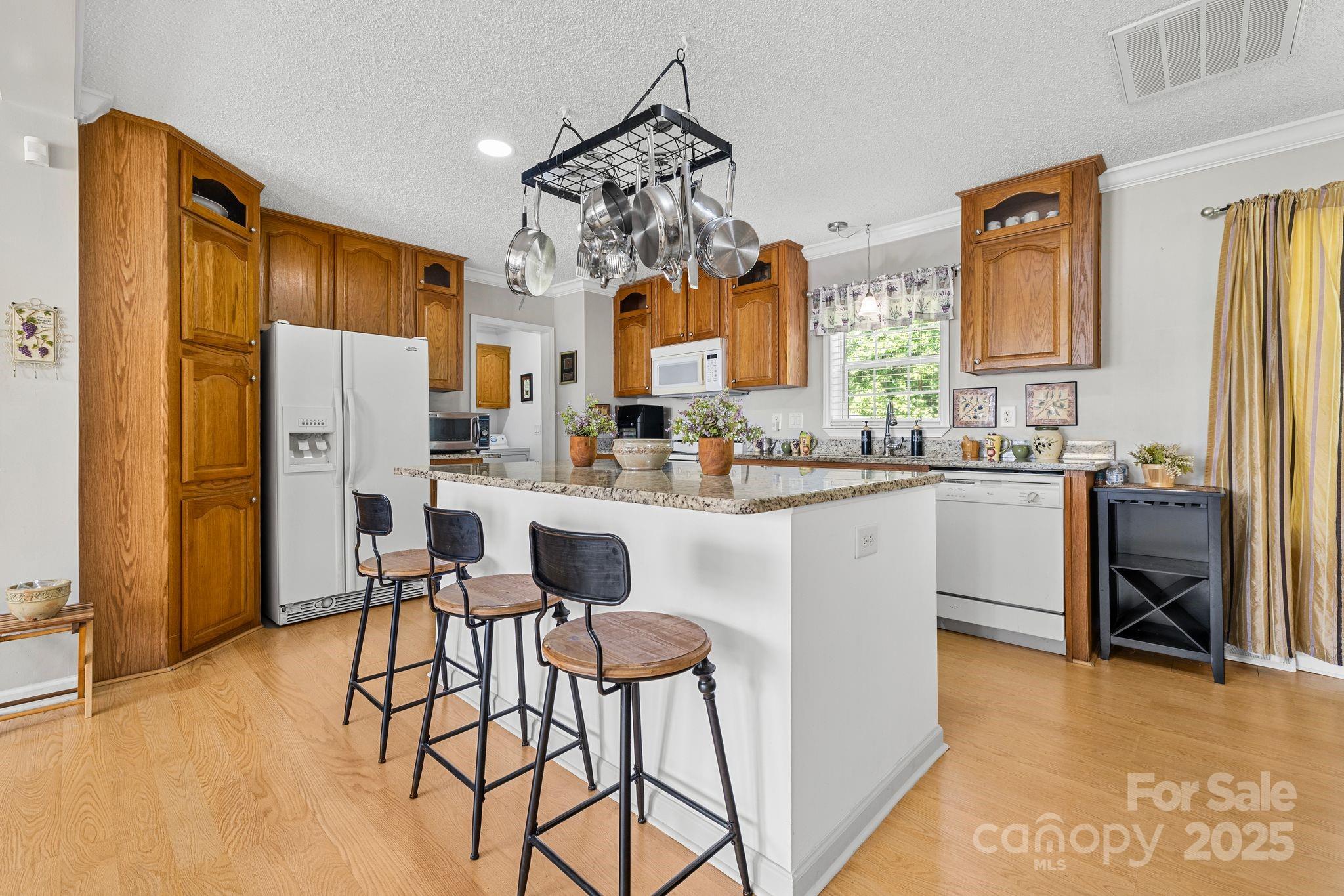 118 Grain Drive Stony Point, NC 28678 - Photo 7 of 31 a kitchen with stainless steel appliances a refrigerator a stove a sink dishwasher and white cabinets next to a window