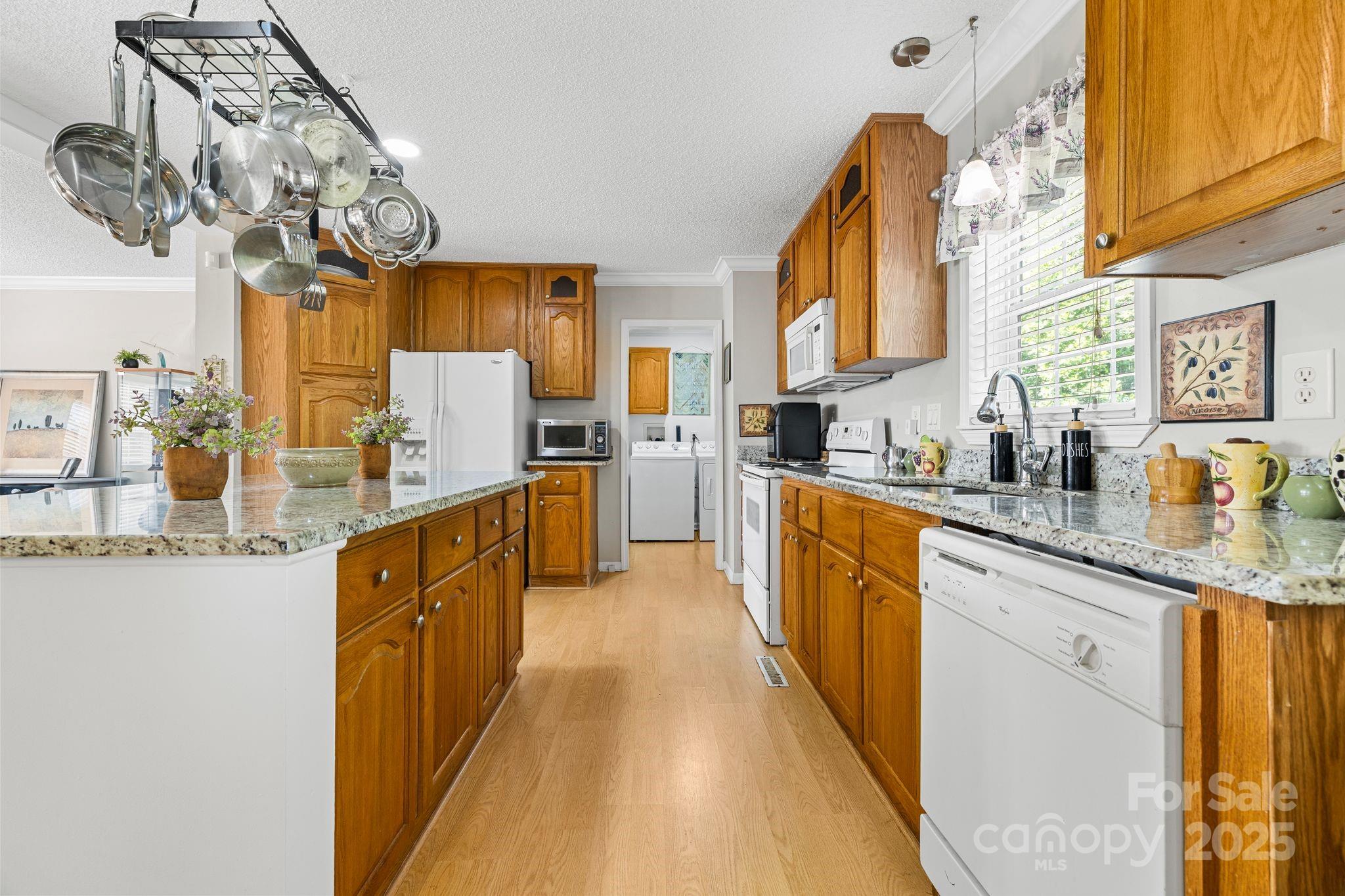 118 Grain Drive Stony Point, NC 28678 - Photo 8 of 31 a kitchen with stainless steel appliances granite countertop a sink a stove top oven a chimney and cabinets