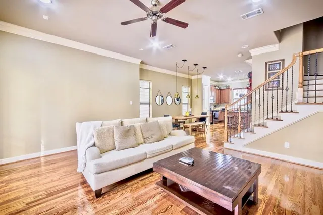 a living room with lots of furniture and a wooden floor