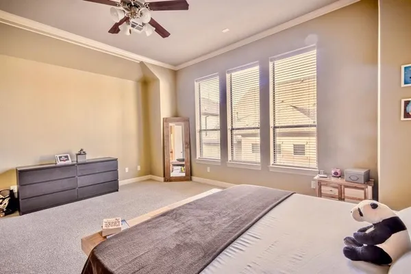 a spacious bedroom with a bed and window