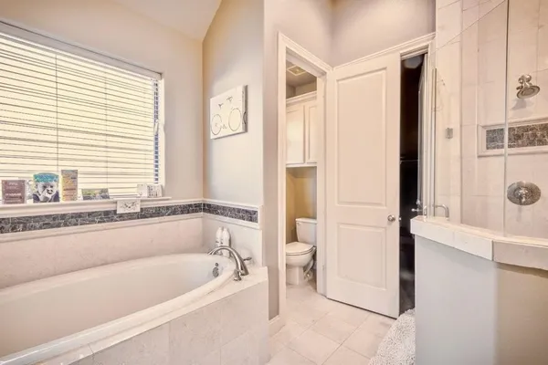 a bathroom with a bathtub and a shower