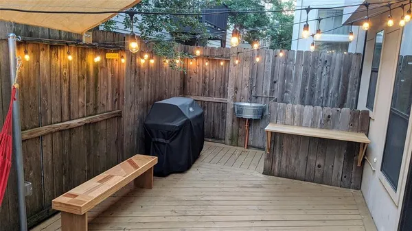 a view of a deck with wooden floor and furniture