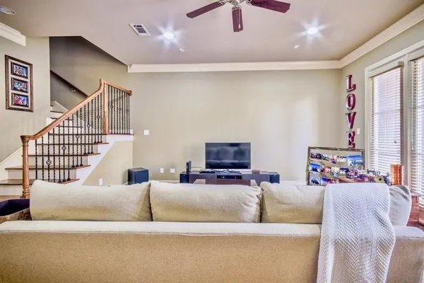 a living room with furniture and a flat screen tv