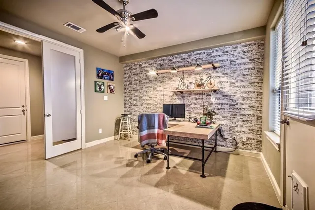 a work room with furniture and a large window