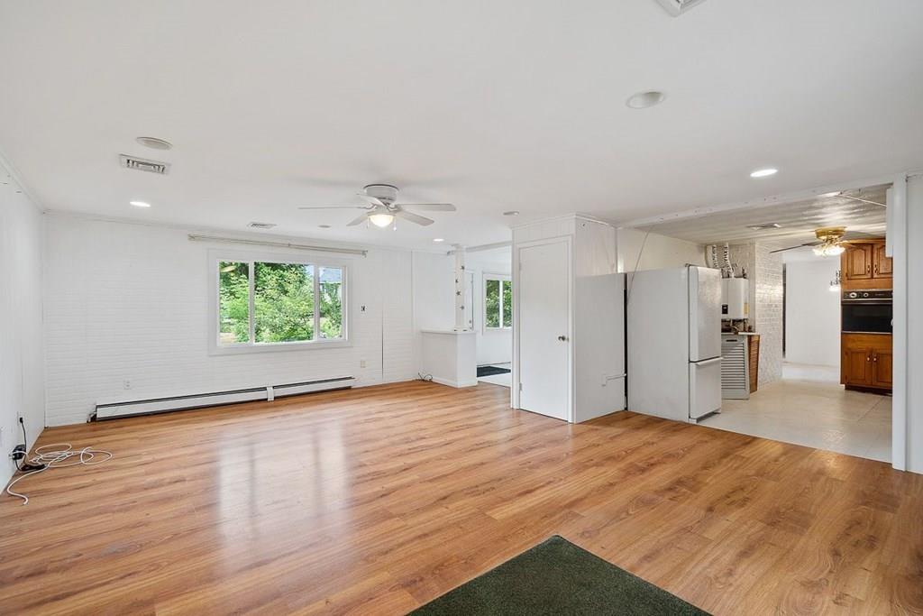 9 Temi Road Chelmsford, MA 01824 - Photo 11 of 28 a view of a big room with wooden floor and a window