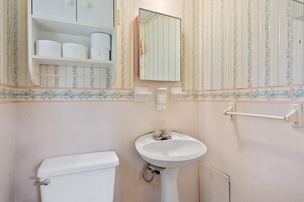 9 Temi Road Chelmsford, MA 01824 - Photo 18 of 28 a bathroom with a sink a toilet and mirror
