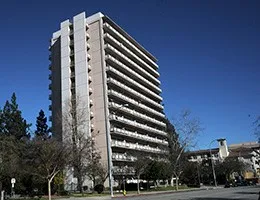 a front view of a building with trees