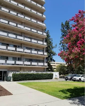 a front view of a building with trees
