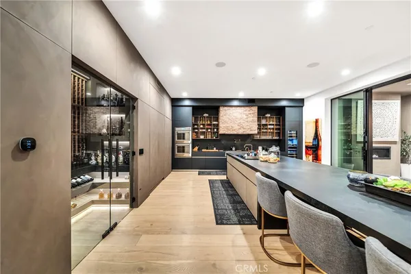 a large white kitchen with a large window