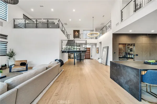 a view of a kitchen with kitchen island stainless steel appliances a stove top oven