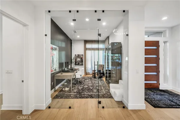 a large living room with stainless steel appliances kitchen island granite countertop furniture and a fireplace