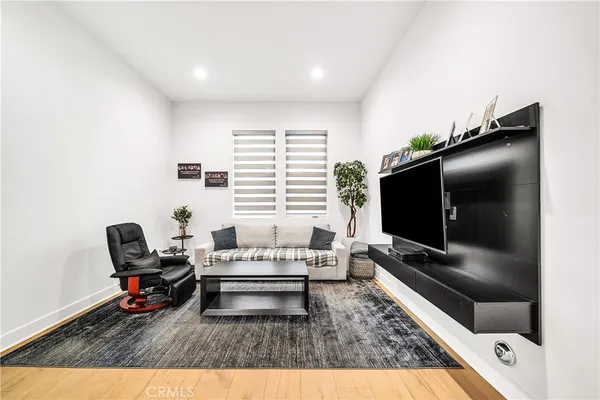 a view of a patio with table and chairs potted plants with wooden floor