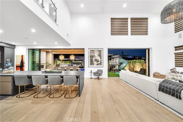 a view of a patio with table and chairs with wooden floor and fence with plants