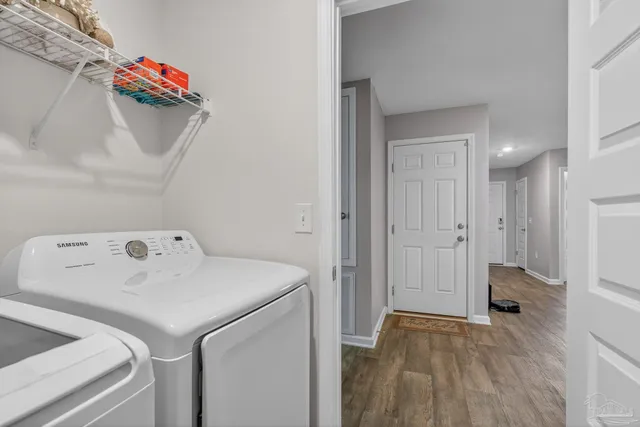 a kitchen with stainless steel appliances granite countertop a lot of counter top space and wooden floor