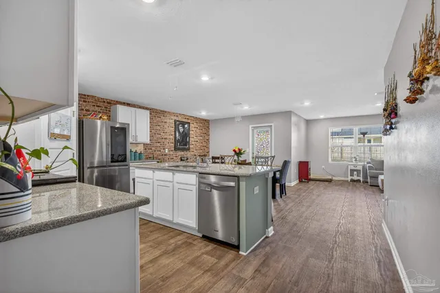 a kitchen that has a sink and a stove top oven