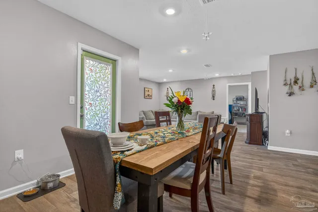 a view of a dining room with furniture and wooden floor