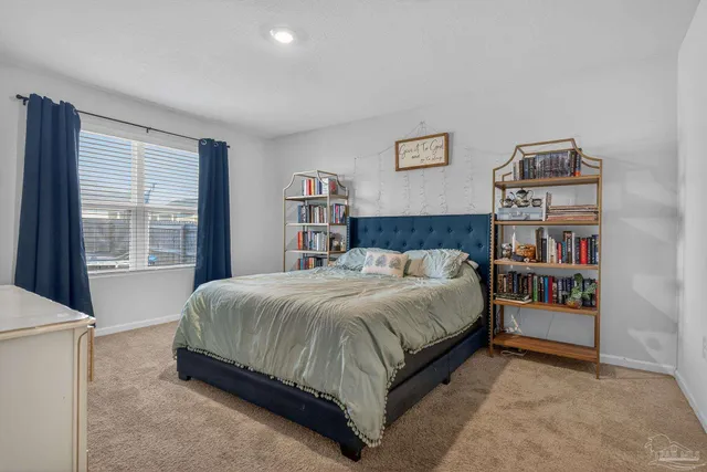 a en suite bathroom with a granite countertop sink and a mirror