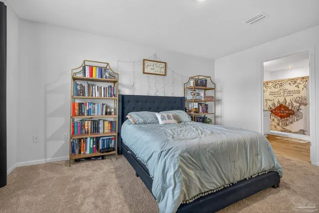 a view of a hallway with bathroom and wooden floor