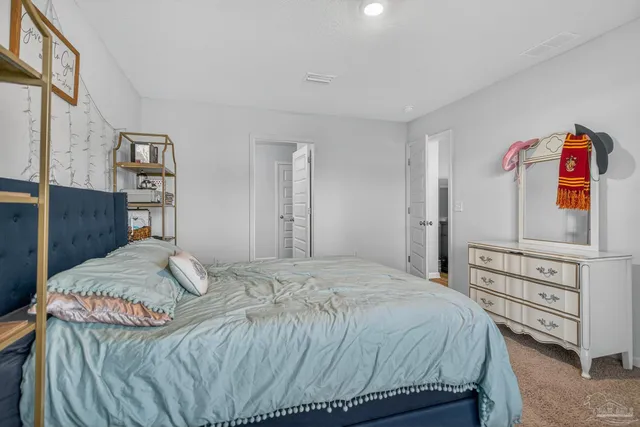 a view of walk in closet with clothes