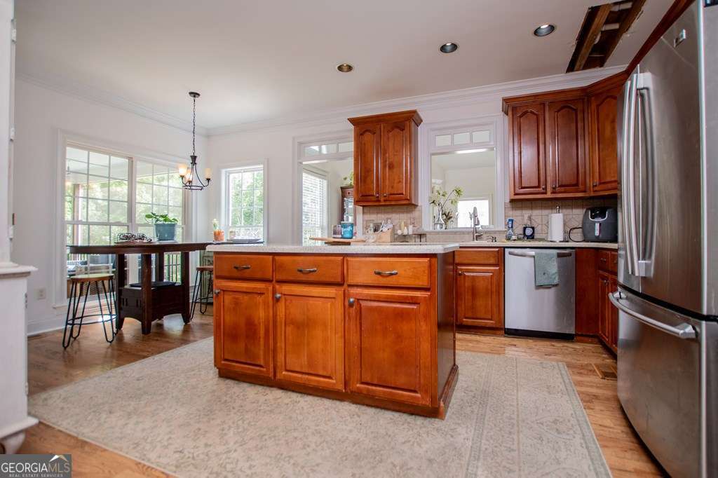 204 Pinehurst Way Carrollton, GA 30116 - Photo 16 of 61 a kitchen with kitchen island granite countertop a sink stove and cabinets