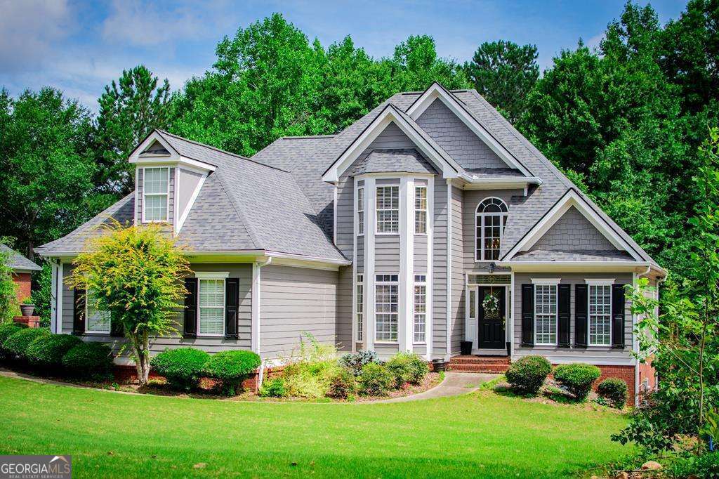 204 Pinehurst Way Carrollton, GA 30116 - Photo 2 of 61 a front view of a house with a yard and potted plants