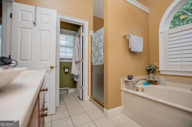 a bathroom with a sink a toilet and a shower