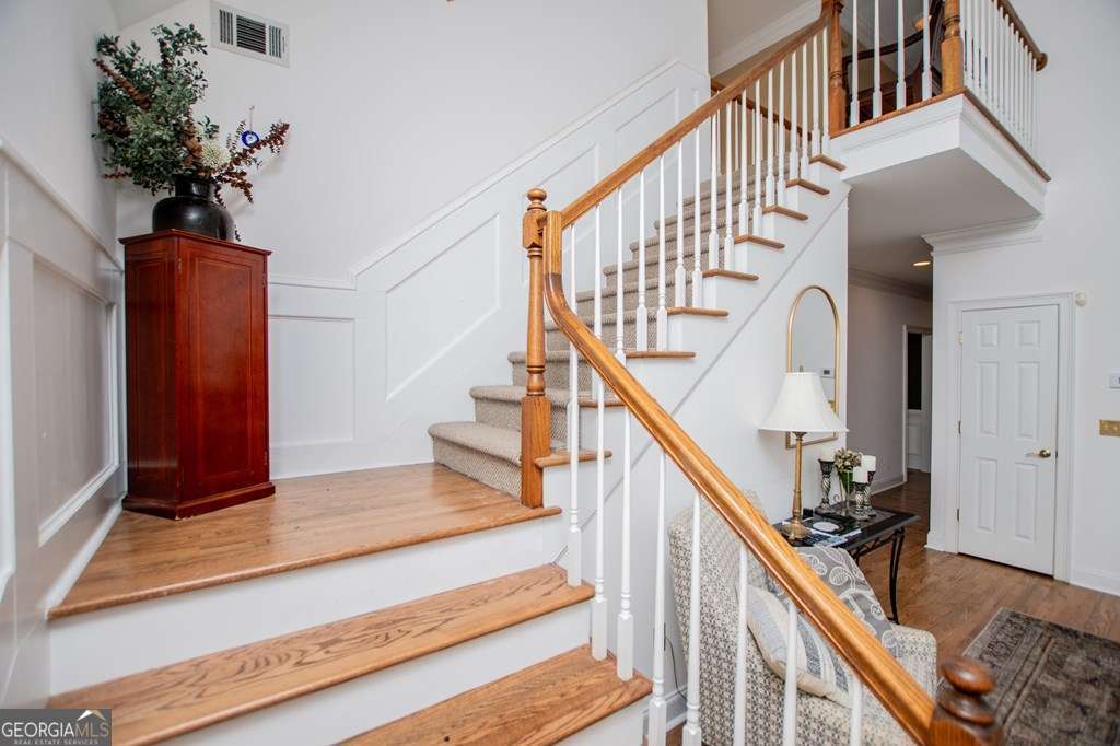 204 Pinehurst Way Carrollton, GA 30116 - Photo 24 of 61 a view of staircase with wooden floor and a potted plant
