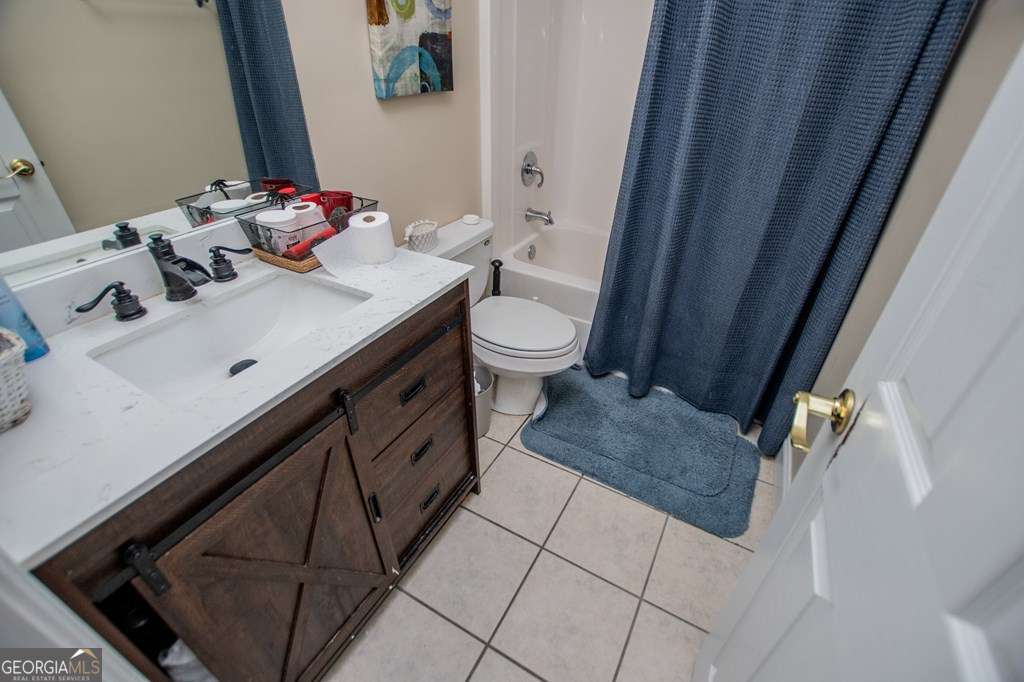 204 Pinehurst Way Carrollton, GA 30116 - Photo 28 of 61 a bathroom with a sink a toilet and mirror