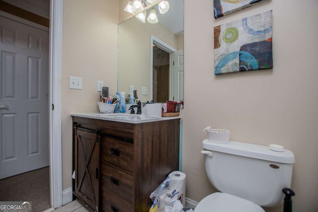 204 Pinehurst Way Carrollton, GA 30116 - Photo 29 of 61 a bathroom with a toilet a sink and mirror