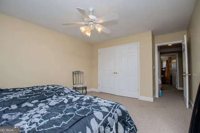 a living room with furniture tv and a large window