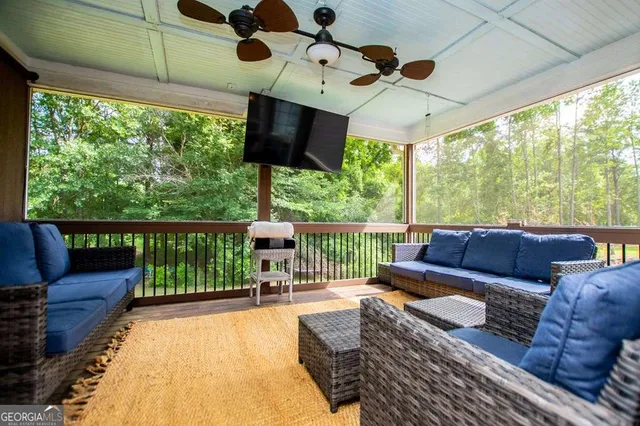 a kitchen with stainless steel appliances granite countertop a stove a refrigerator a sink dishwasher a dining table and chairs with wooden floor