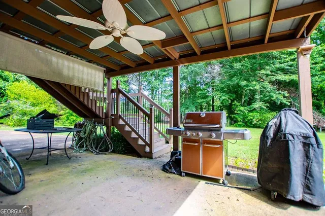 an aerial view of residential house with outdoor space and trees all around