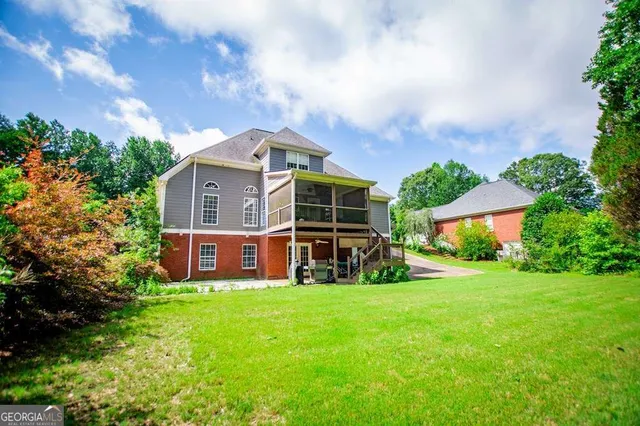 an aerial view of a house with swimming pool and garden