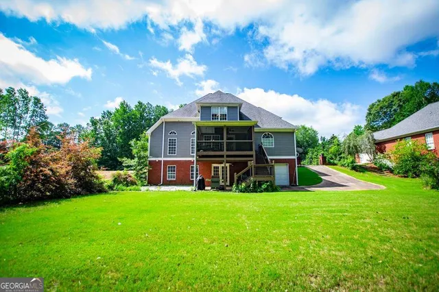 a aerial view of a house with a yard and potted plants