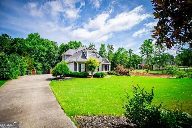 a view of a a dining room with furniture window and wooden floor