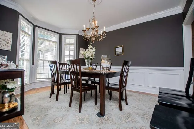 a view of a dining room with furniture and a chandelier
