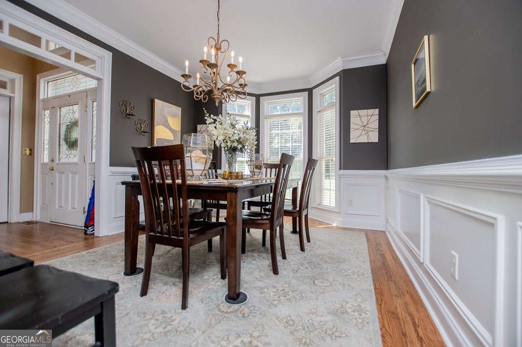 204 Pinehurst Way Carrollton, GA 30116 - Photo 8 of 61 a view of a dining room with furniture and a chandelier