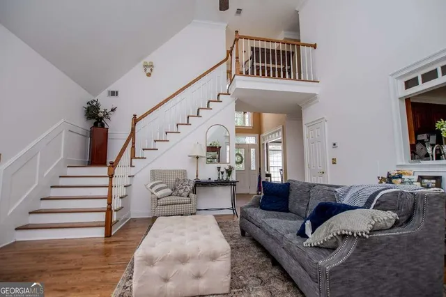 a living room with furniture and a stairs