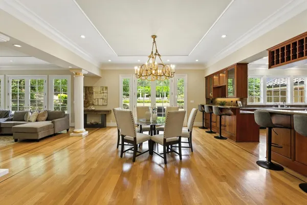 a large kitchen with kitchen island a large counter top space a sink stainless steel appliances and cabinets