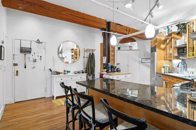 a view of dining table chairs and chandelier