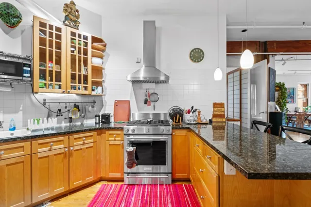 a kitchen with stainless steel appliances granite countertop a sink and cabinets