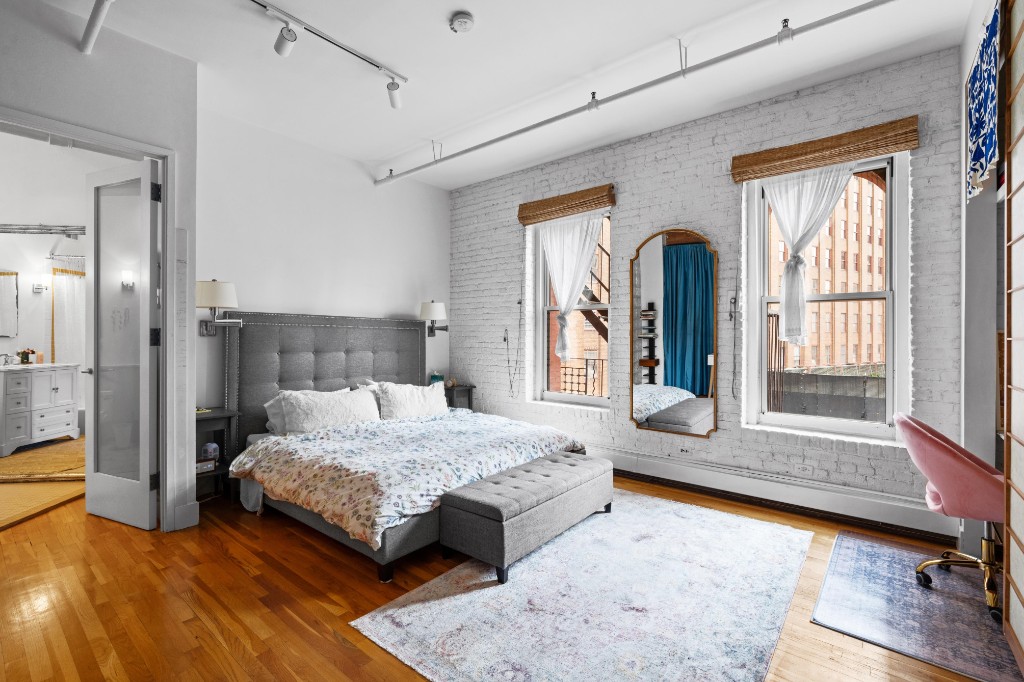 165 Duane Street, Unit 6A Manhattan, NY 10013 - Photo 17 of 29 a bedroom with a bed and large windows