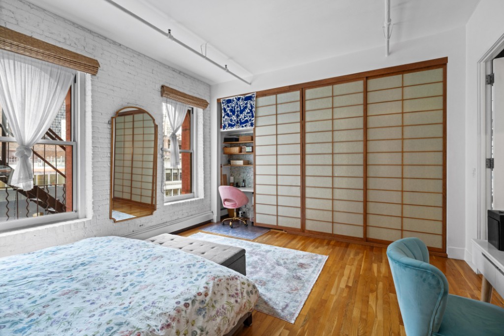 165 Duane Street, Unit 6A Manhattan, NY 10013 - Photo 18 of 29 a bedroom with a bed and a large window with outer view