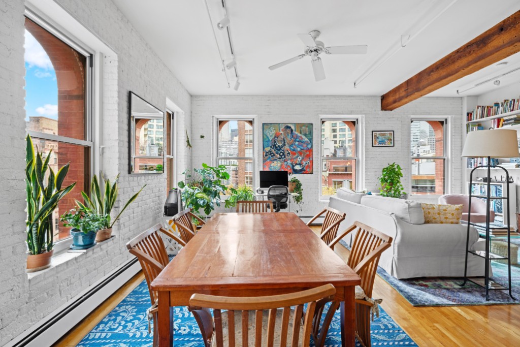 165 Duane Street, Unit 6A Manhattan, NY 10013 - Photo 2 of 29 a view of a dining room with furniture window and wooden floor
