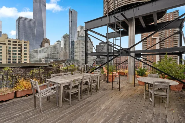 a view of a roof deck with table and chairs
