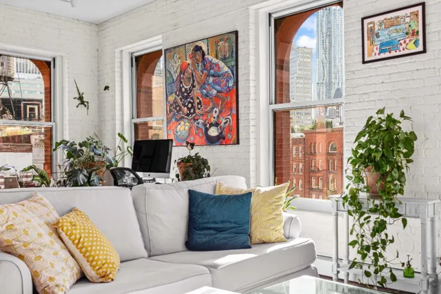 a living room with furniture and flowers