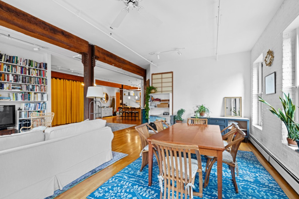 165 Duane Street, Unit 6A Manhattan, NY 10013 - Photo 10 of 29 a living room with furniture fireplace and large windows